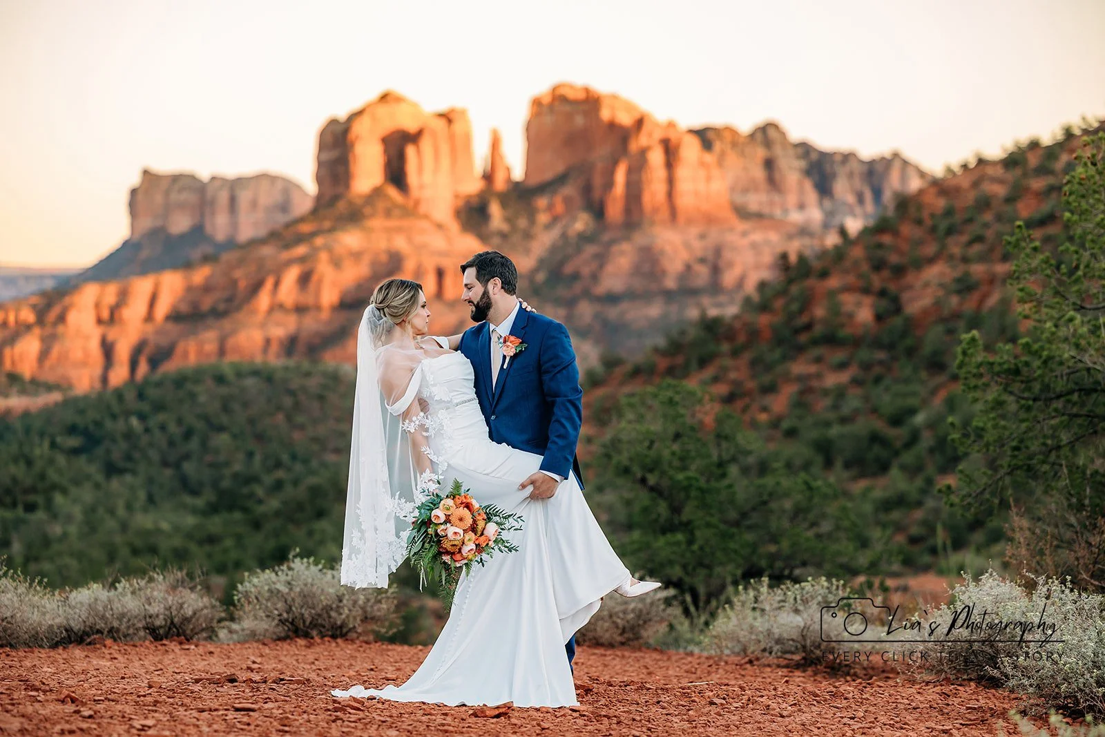 Cathedral Rock — A bride and groom held close on the red rock, Cathedral Rock catching the last of the light behind them.